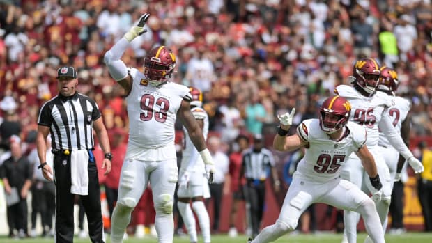 Sep 10, 2023; Landover, Maryland, USA; Washington Commanders defensive tackle Jonathan Allen (93) and defensive end Casey Toohill (95) celebrate after tackling Arizona Cardinals running back Keaontay Ingram (not pictured) behind the line of scrimmage during the first half at FedExField. Mandatory Credit: Tommy Gilligan-USA TODAY Sports